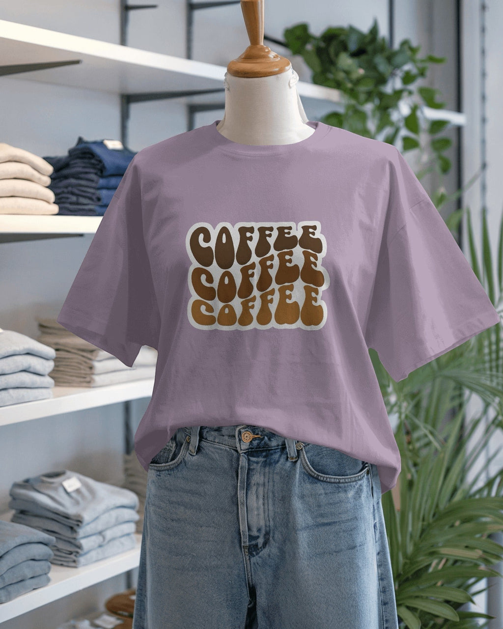 Snubclub lilac oversized t-shirt with a "Coffee Coffee Coffee" graphic in brown retro font. Unisex fit.